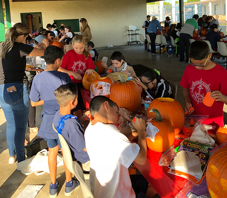 St. Brendan Elementary students work on their STREAM project, turning pumpkin guts into slime.