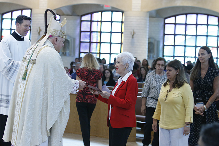 Catechists with more than 20 consecutive years of service, all as volunteers, receive their certificates of appreciation at the Mass that preceded the annual Catechetical Day held Nov. 3 at Archbishop McCarthy High School in Southwest Ranches.