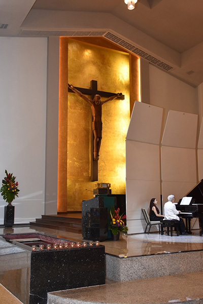 Father Jose Luis Menendez, Corpus Christi's pastor, and 11 attendees lit 11 candles to commemorate victims of the Tree of Life Massacre in Pittsburgh. The candles burned for the entire Martha/Mary-Yamaha concert, the series’ inaugural performace at the church, Nov. 4.