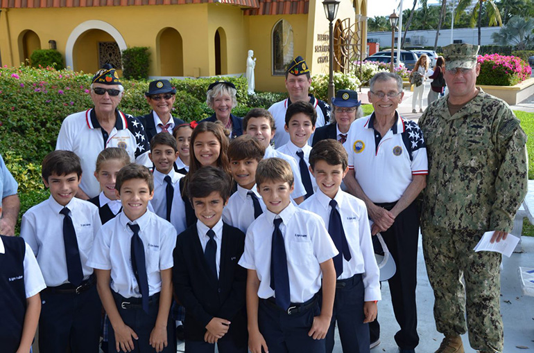 Veterans and members of the American Legion pose with a group of fifth graders at St. Agnes Academy Nov. 7, the day the school celebrated a Mass in remembrance of Veterans Day