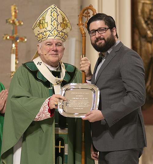 Andres Bayon of Prince of Peace Parish in Miami receives this year's One in Hope award from Archbishop Thomas Wenski. The award highlights his commitment to receiving and sharing God's gifts responsibly.The annual ThanksforGiving Mass acknowledges those who have consistently donated to the Archbishop's Charities and Development appeal, and recognizes new members of the Archbishop Coleman Carroll Legacy Society, who remembered or promised to remember the archdiocese in their will.