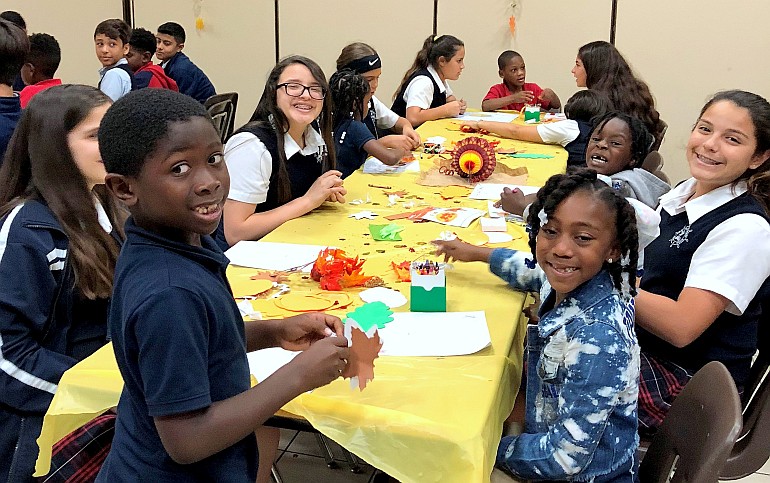 Children join in handicrafts after Thanksgiving dinner at St. Brendan Elementary School.