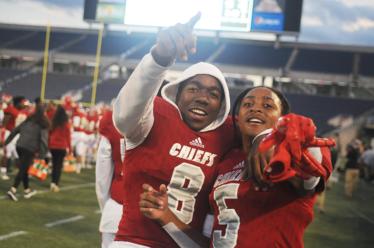 Cardinal Gibbons teammates Sidney Porter, left, and Vincent Davis celebrate their state championship victory over North Marion.