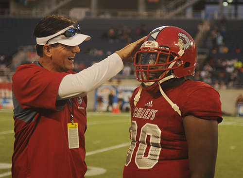 Cardinal Gibbons assistant football coach Lukas Kammatas and defensive lineman Terry Mareus celebrate the Chiefs' victory.