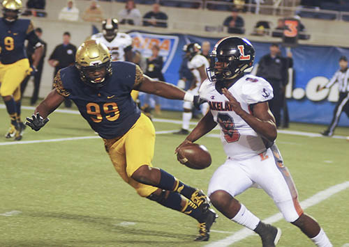 Lakeland quarterback Dywonski McWilliams runs for yardage as St Thomas Aquinas' Tyreak Sapp zeroes in for the tackle on Friday, Dec. 7.