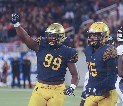 St. Thomas Aquinas defenders Tyreak Sapp, left, and Derek Wingo celebrate a third-down stop by signaling fourth down in the first half Friday against Lakeland.