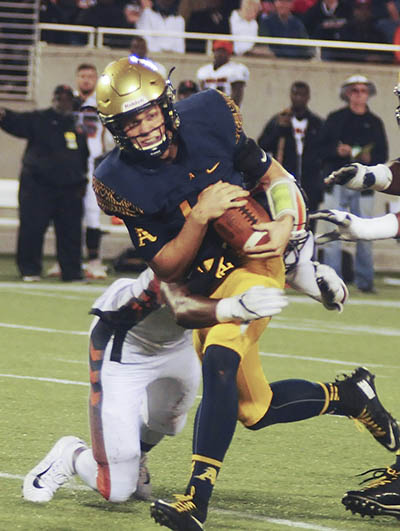 St. Thomas Aquinas quarterback Curt Casteel tries to break a tackle by Lakeland's Lloyd Summerall during the second half Friday.