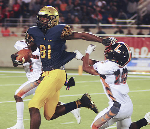 St. Thomas Aquinas receiver Marcus Rosemy (81) stiff-arms Lakeland defender Jay Rolle as Lakeland's Fenley Graham (1) races in for the tackle Friday at the FHSAA 7A state championships.