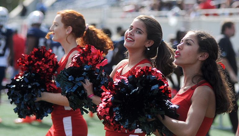 Chaminade-Madonna cheerleaders (from left) Olivia Callari, Lorrany Oliveira and Gabriella Pollio cheer on their Lions in the second half against West Palm Beach King's Academy on Saturday, Dec. 8.