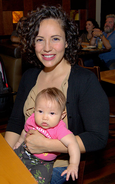 Raquel Acosta holds Noella, her 5-month-old daughter, during the inaugural dinner of Marriage Uncorked.