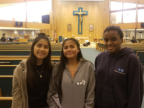 Saint Andrew students, from left, Miranda Curi, Sofia Curi, and Thereza Zephir pose for a photo after the Steve Angrisano concert.