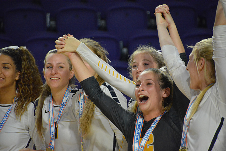 St. Thomas Aquinas volleyball players cheer after being crowned state champs Nov. 17 in Fort Myers.