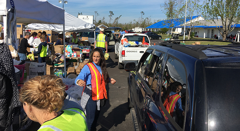 Volunteers from St. Thomas the Apostle Parish in Miami help distribute toilet paper and other necessities at the drive-thru distribution center set up at the heavily damaged St. Dominic Church in Panama City, Nov. 17. “The line of cars would not stop, we could not take a break,” said Catalina Pittier, who went on the trip with her husband and two school-aged daughters.