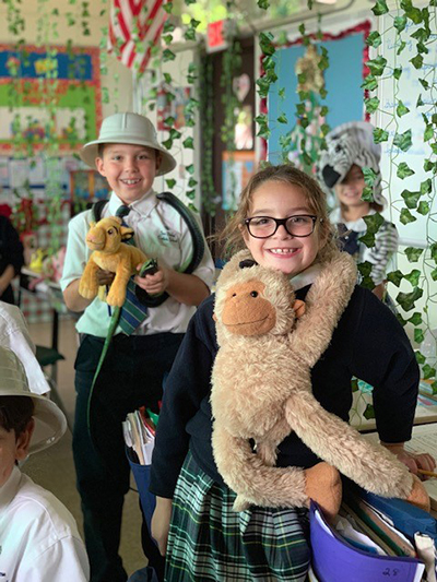 Students Cormac Riley and Madeline Rodriguez pose with their African animals.