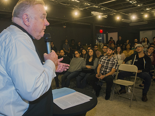 Archbishop Thomas Wenski addresses young adults at Theology on Tap, Dec. 20 at The Tank Brewery in Doral.