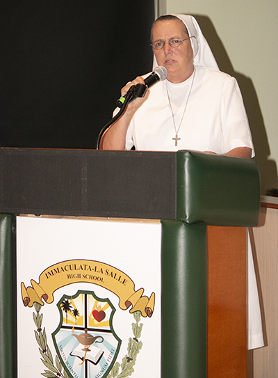 Sister Kim Keraitis, principal of Immaculata-La Salle High School in Miami, assures the Pedro Pan and school alumni that the school “is always here for you. All you have to do is come home at any time.