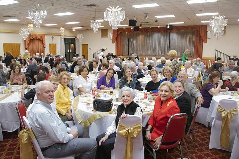 Parishioners gather for a reception after the Mass marking the start of a year-long celebration of St. Henry Church's golden jubilee. In the center table are members of the parish's Venezuelan group.