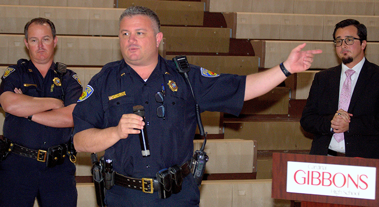 Lt. Charlie Studders of the Fort Lauderdale Police Department, center, speaks during a session on coping with active shooter situations at Cardinal Gibbons High School. Listening are FLPD Captain Patrick Hart, left, and Assistant Principal Oscar Cedeño of Gibbons.