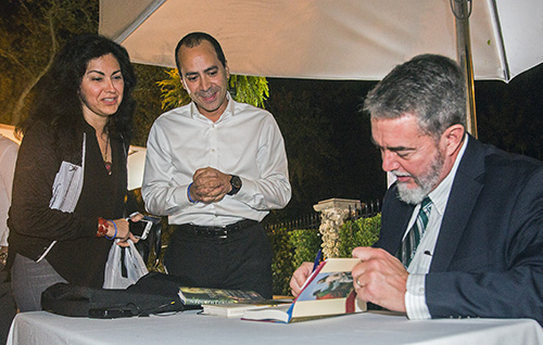 Vedro and Fabiola Torres watch as Scott Hahn signs a copy of his book, "Reason To Believe."