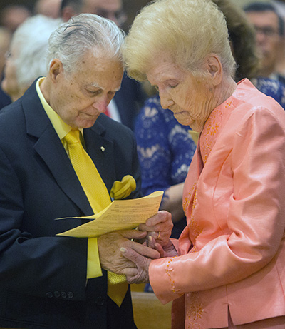 A jubilarian couple renew their wedding vows during the annual Mass for married couples celebrated by Archbishop Thomas Wenski Feb. 16 at St. Mary Cathedral.