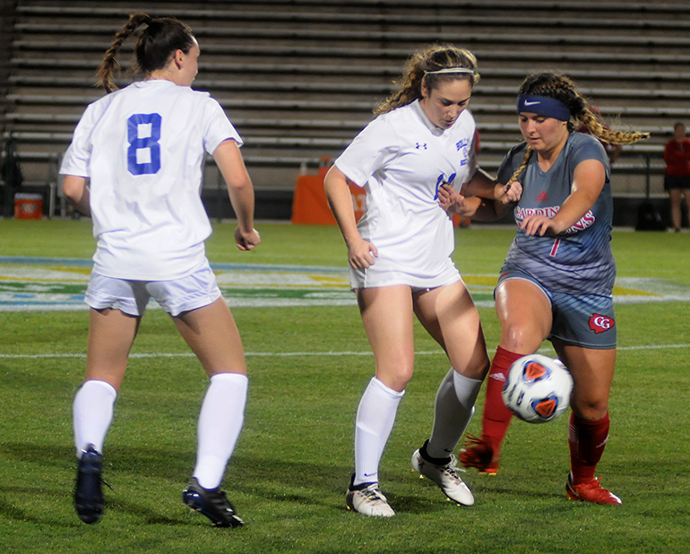 Cardinal Gibbons midfielder Brandi Orlando, right, duels Bolles midfielders Amelia Emas, center, and Aubrey Ramey during the first half Wednesday, Feb. 20, 2019. Bolles defeated Cardinal Gibbons 5-1 at Spec Martin Stadium in DeLand. It was Cardinal Gibbons' first state final since 2009.