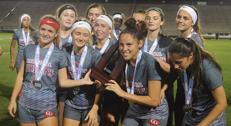 Cardinal Gibbons players pose with the state runner-up trophy Wednesday, Feb. 20, 2019. Bolles defeated Cardinal Gibbons 5-1 at Spec Martin Stadium in DeLand. It was Cardinal Gibbons' first state final since 2009.