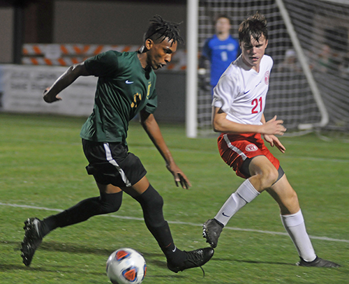 Immaculata La Salle forward Juan Diego Cozzo, left, tries to shake the defense of Lake Highland Prep defender George Clendenin during the second half of their Class 2A boys soccer final against Orlando Lake Highland Prep.