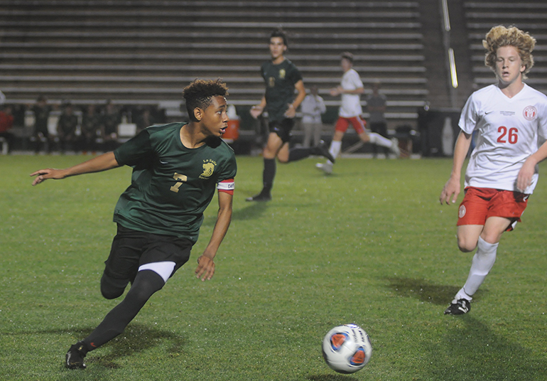 Immaculata La Salle midfielder Stephen Linton looks to pass the ball past Lake Highland Prep midfielder Wes Seneff during the second half of their Class 2A boys soccer final against Orlando Lake Highland Prep.