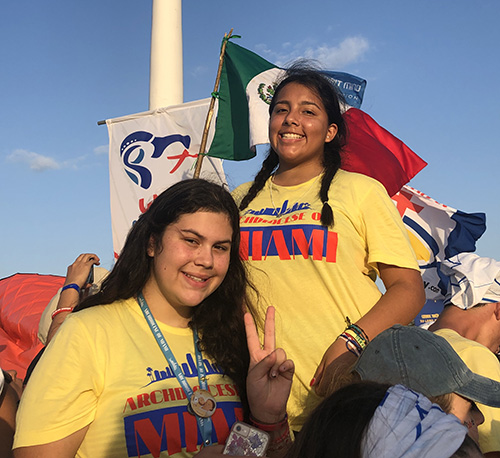 Izzy Rennella, top right, who went with a group from Little Flower Church in Coral Gables, poses with fellow Miami pilgrim Gabriella Mora, of Blessed Trinity Parish in Miami Springs, after arriving at the park where the overnight vigil and Mass with Pope Francis would take place, the weekend of Jan. 26 and 27.