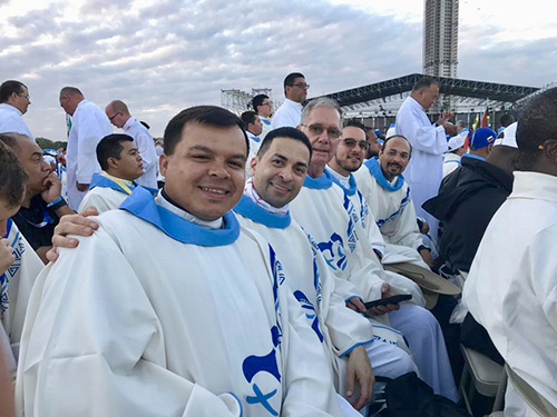 Archdiocesan priests pose for a photo before concelebrating the final Mass of World Youth Day in Panama with Pope Francis. From left: Father Elvis Gonzalez, vocations director; Father Jose Alfaro, pastor of Blessed Trinity, Miami Springs; Father James McCreanor, retired pastor of Sacred Heart in Homestead; Father Bryan Garcia, administrator of St. Bernadette in Hollywood; and Jesuit Father Christian Saenz, who accompanied a group of students from Belen Jesuit Prep in Miami.