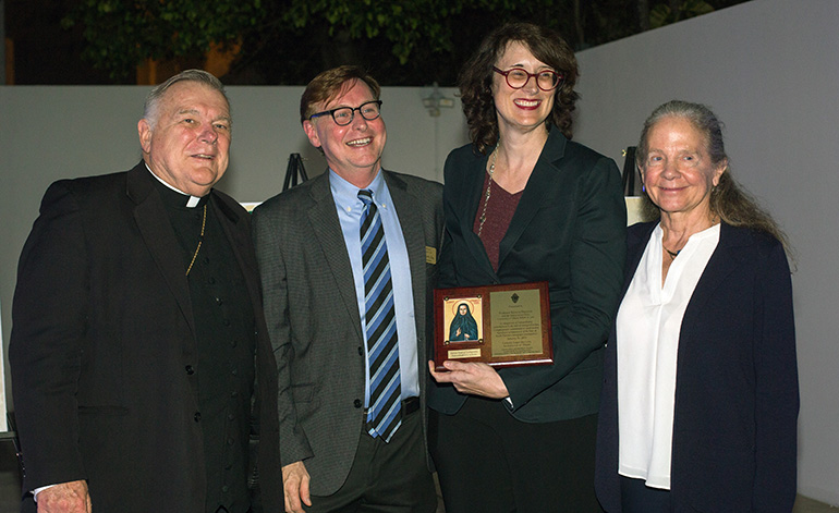 From left: Archbishop Thomas Wenski and Randolph McGrorty, CEO of Catholic Legal Services, pose with Mother Cabrini award recipient Rebecca Sharpless, professor of Clinical Legal Education at the University of Miami and director of UM's Immigration Clinic, and Patricia White, dean of UM's law school.