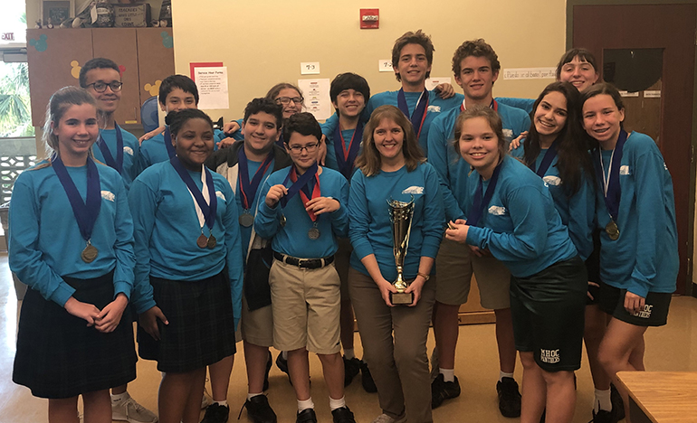 Mary Help of Christians' 2018-19 Science Olympiad team, which won the regional competition and will compete at the state level next, consists of sixth graders Mila Bond, Oscar Doughtery, and Zoryn Jean; seventh graders Zachariah Dookhan, Julia Dybas, Elizabeth James, Lucas Opperman, Nathaniel Pistorius, and Miguel Villareal-Rojas; and eighth graders Lucas Benitez, Grace Cavarretta, Melissa Dixon, Rafael Opperman, Victoria Servideo, and Thomas Zambrano. They are led by teacher Donna Hanrahan.