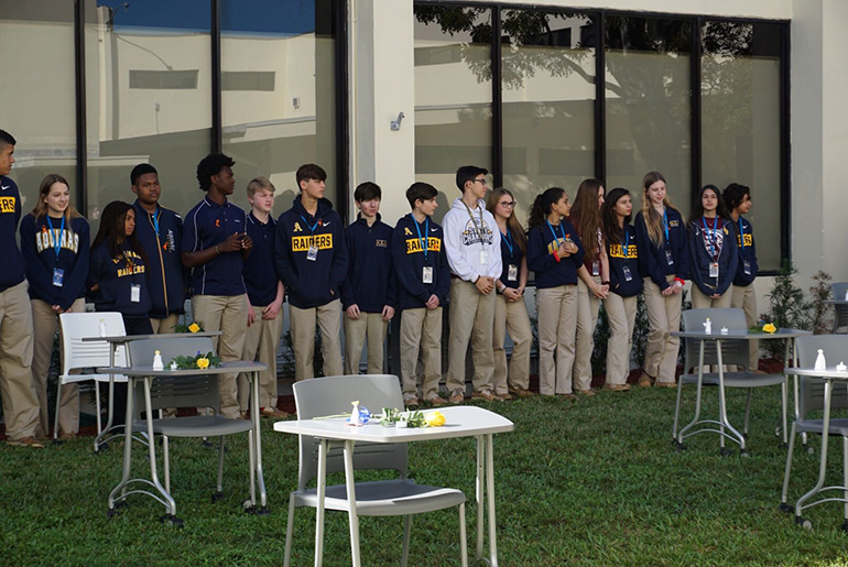 Students in a senior the theology class at St. Thomas Aquinas High School spend some time outside reflecting on the meaning of love, the people they love and how God loves them on Valentine's Day 2019, the first anniversary of the shooting at Marjory Stoneman Douglas High School in Parkland. The empty desks recall the 17 students and three faculty and staff who lost their lives on Valentine's Day 2018.