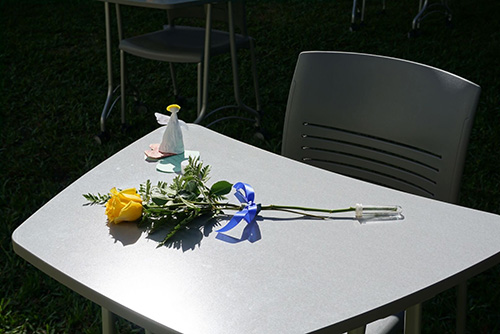 To mark the one-year anniversary of the shooting at Marjory Stoneman Douglas High School in Parkland, students at St. Thomas Aquinas High School in Fort Lauderdale set out 17 desks in one of the school's interior hallways, in memory of each of the victims. On the desks they placed a yellow flower, a candle and an angel. Throughout the day, classes would stop by and say a prayer, listen to a reflection or spend a moment in silence.