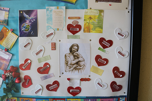 A poster board near the entrance of Mary Help of Christians Church bears the names of the victims killed in the Parkland school shooting.