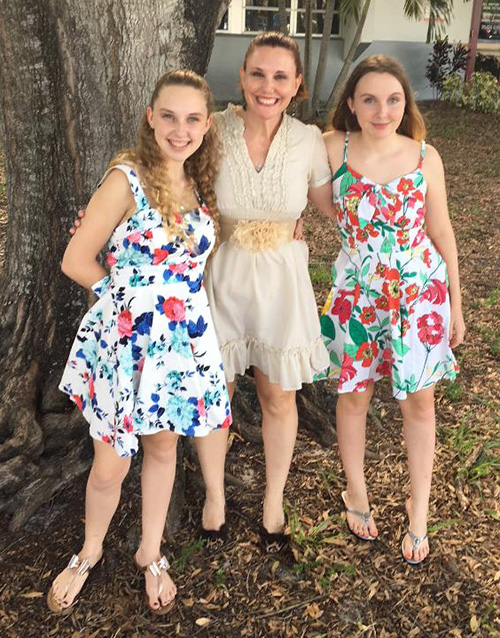 Mary Help of Christians parishioner Alison Carew poses with her twin daughters Madison, left, and Mackenzie. The girls are in 10th grade this year at Marjory Stoneman Douglas High School and are trying to move forward after the death of their classmates.