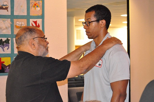 Men pray for each other during one of the ManUp conferences held at St. Edward Church in Pembroke Pines.