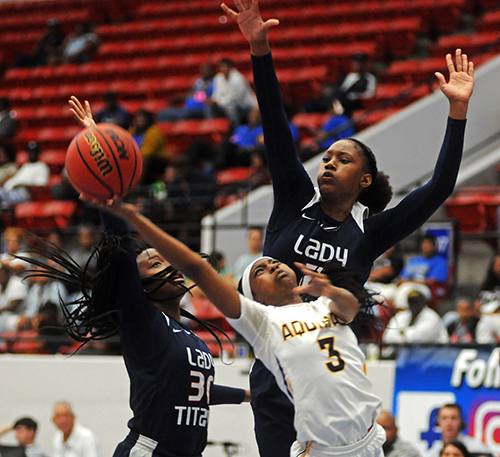 St. Thomas Aquinas guard Samara Spencer (3) tries for a layup between Tampa Bay Tech's Amiya Evans, left, and Janiah Barker in the first half of Tampa Bay Tech's 58-52 overtime victory March 2 in the FHSAA Class 8A girls basketball state championship game at the RP Funding Center in Lakeland.