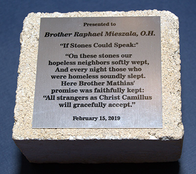 This short poem, inscribed on a block of Camillus House, was presented to Hospitaller Brother Raphael Mieszala at his farewell reception.