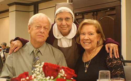 Sister Carmen Ors, of the Servants of the Pierced Hearts of Jesus and Mary, poses with her former boss, retired Respect Life director Joan Crown, and Crown's husband, Chic, at the Miami Archdiocesan Council of Catholic Women's 20th annual Scholarship Luncheon, held Feb. 23 at the Embassy Suites in Fort Lauderdale.