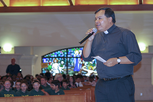 Father Elvis Gonzalez, director of vocations for the Archdiocese of Miami, welcomes students to the Focus 11 vocations rally Feb. 27 at host St. Gregory Parish in Plantation.