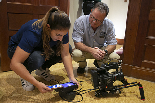 Kelsey Gibson and John Oliva of Digital Cut Productions look over their work while taping a Reconciliation Weekend promotional video at St. Mary Cathedral.