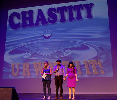 Host Natalie Chaiser, left, joins Gus and Caitlin De La Fe in prayer to wrap up Chastity Day rally, held in Pembroke Pines.