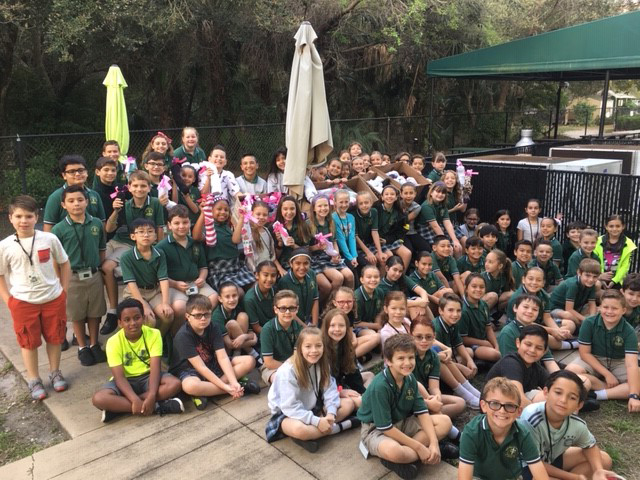 Third- and fourth-graders at Mary Help of Christians School in Parkland pose with some of the Socks of Love they collected for the needy and homeless.