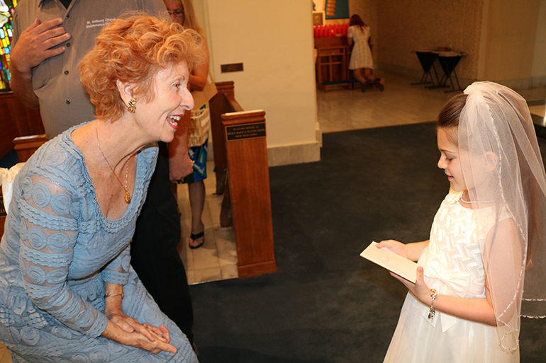 Dolores McDiarmid of St. Anthony Parish greets Delaney Lefka, the first communicant who had been at the center of her prayers over the past months.