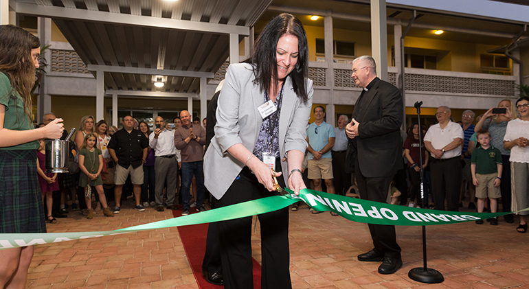 Alexandra Fernandez, principal, cuts the ribbon March 4 during the official blessing and opening of Mary Help of Christians Catholic School Parish & Student Center in Parkland. Miami Archbishop Thomas Wenski blessed the facilities serving northwestern Broward County during a ribbon cutting ceremony.