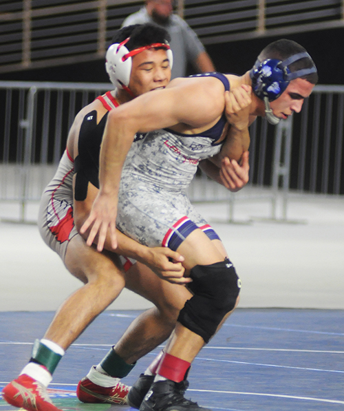 Cardinal Gibbons' Jonathan Ley, left, tries to gain position on Orlando Lake Highland Prep's Chris Rivera in the Class 1A 145-pound weight class at the FHSAA Wrestling Finals on Saturday, March 9, 2019, at the Silver Spurs Arena in Kissimmee.