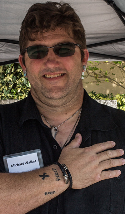 Michael Walker, a catechumen who almost died in 2017, displays a tattoo with the date of his near-death experience, 4-12-17.