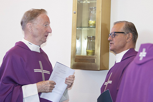 Past presidents of St. Thomas University, Father Patrick O'Neill, left, and Msgr. Franklyn Casale, talk before the Mass that preceded the inauguration of David A. Armstrong as 10th president of St. Thomas University, Miami Gardens, March 20, 2019.