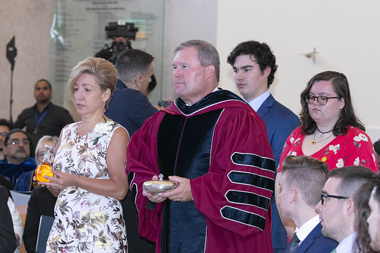 St. Thomas University's 10th president, David A. Armstrong, and his wife, Leslie, left, along with their children David, 20, and Johanna, 18, take up the offertory during the Mass that preceded Armstrong's inauguration as 10th president of St. Thomas University, Miami Gardens, March 20, 2019.